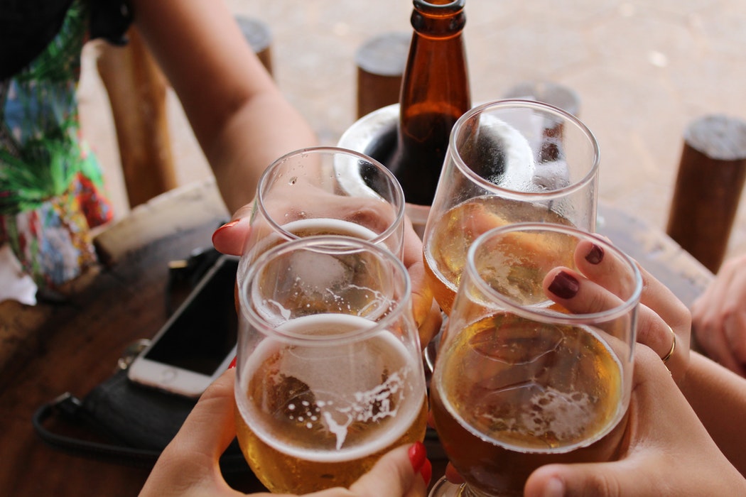 A group of people drinking beers.