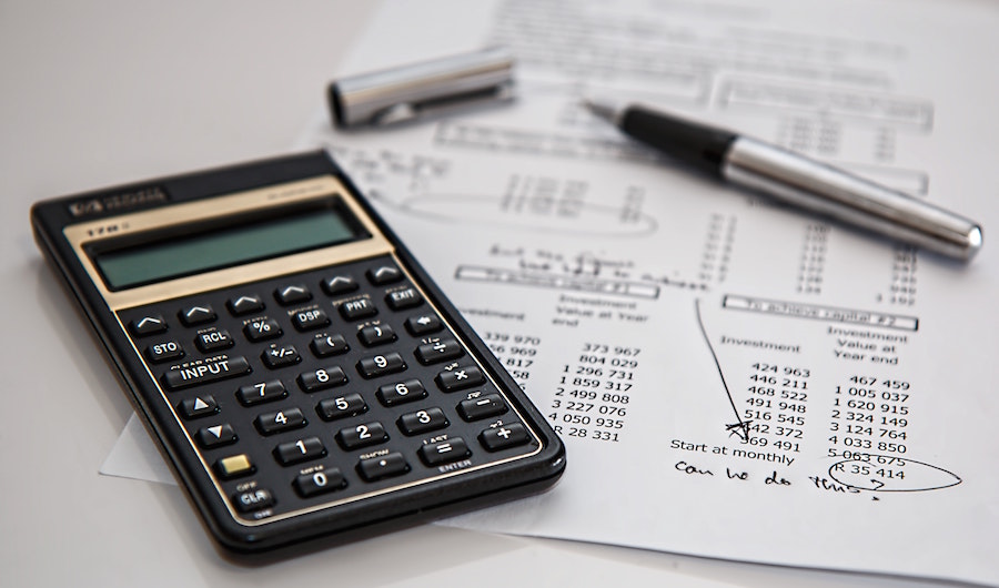 Calculator with pen and financial forms