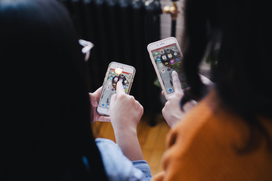 Two women using smartphones